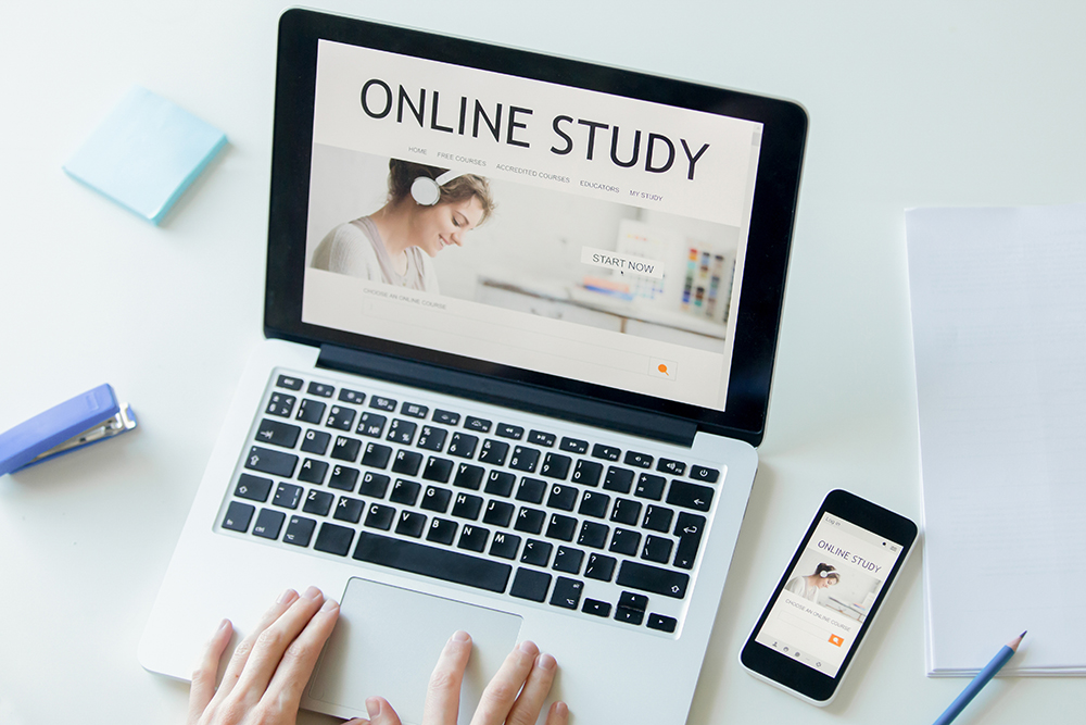 Online degree study materials and laptop